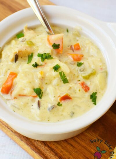 Creamy chicken wild rice soup with tender chicken, carrots, celery, and wild rice in a white bowl